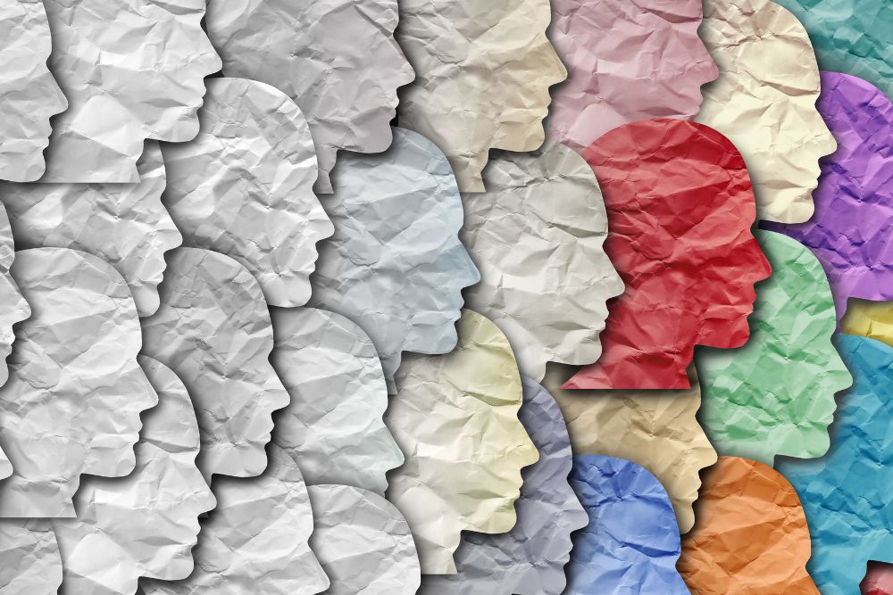 Crumpled paper profiles in varied colors symbolizing diversity, individuality, and collective mindset in organizational culture